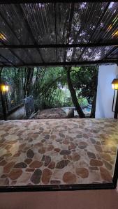 a view of a patio with a stone floor at Pilarica Gardens in Medellín