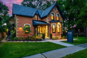 a brick house with a blue mailbox in front of it at Somewhere Inn Collingwood Boutique Hotel in Collingwood