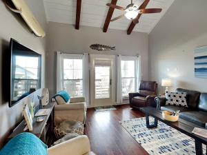 a living room with a couch and a table at Beach Please in Port Aransas