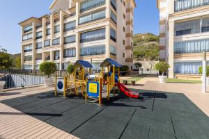 a playground in front of a building at Fidalsa Guardamar Resort in Guardamar del Segura