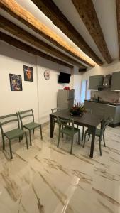 a dining room with a table and chairs and a kitchen at Ca lucia Canal View in Venice