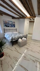 a bedroom with a bed in a room with marble floors at Ca lucia Canal View in Venice