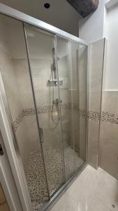a shower with a glass door in a bathroom at Ca lucia Canal View in Venice