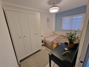 a small bedroom with a bed and a table at Sunset 8F in Santa Pola
