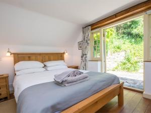 a bedroom with a bed and a large window at 3 Bed in Lulworth Cove DC023 in West Lulworth