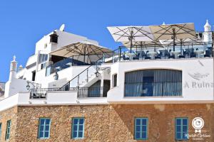 a building with chairs on top of it at AREIAS SOL in Albufeira