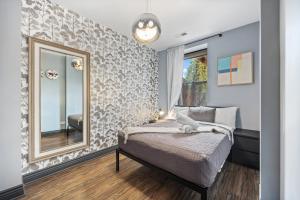 a bedroom with a bed and a large mirror at McCormick Place Guest House in Chicago