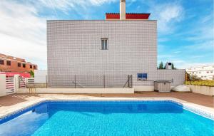 a swimming pool in front of a building at Amazing Home In Playa De Almazora With Kitchen in San Antonio