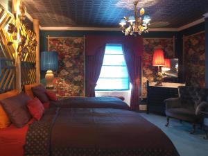 a bedroom with a bed and a window at Carrington House in Snettisham