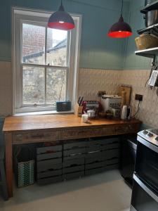 a kitchen with a wooden counter with a window at Hastings Old Town Gorgeousness in Hastings