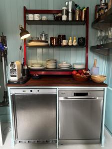 a kitchen with a counter with dishes on a shelf at Georgian Russell in Hastings