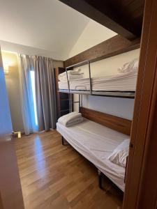 a small room with two bunk beds in it at Résidence CERDANYA in Bourg-Madame