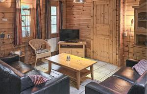 a living room with couches and a table and a television at Lovely Home In Neede With Sauna in Neede