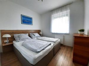 Postel nebo postele na pokoji v ubytování Kendosz Apartman