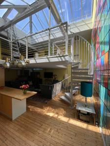 a large room with a staircase in a building at Victoria Park Apartment in London