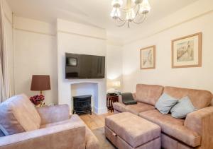 a living room with a couch and a fire place at Old Fishermans Cottage - East Runton in West Runton