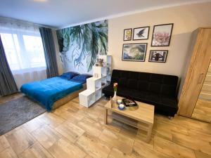 a living room with a bed and a couch at Mokka Apartament in Warsaw