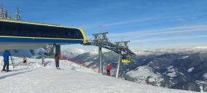 a ski lift at the top of a snow covered mountain at Panoramic House in Borsa