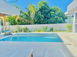 a swimming pool in the backyard of a house at Ocean Pearl - Getaway Holiday home in Long Bay Hills