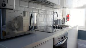 a kitchen with a sink and a microwave at Ideal location! Studio flat in heart of the city in Bristol