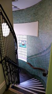 a spiral staircase in a building with a window at Ideal location! Studio flat in heart of the city in Bristol