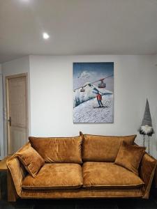- un canapé dans le salon avec une photo d'une remontée mécanique dans l'établissement Les Fées Mer : appart 150 m² hypercentre calme 10p, à Chamonix-Mont-Blanc
