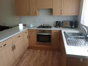 a kitchen with a sink and a stove top oven at The Annexe in Bridlington