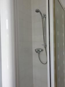 a shower with a shower head in a bathroom at The Annexe in Bridlington