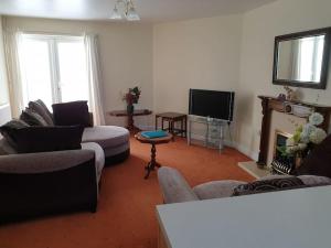 a living room with two couches and a television at The Annexe in Bridlington