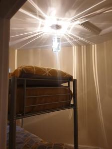 a bedroom with a bed with a light on the ceiling at The Annexe in Bridlington