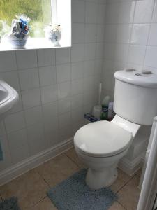 a bathroom with a white toilet and a sink at The Annexe in Bridlington