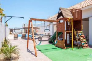 a playground with a slide and a play house at Spacious home with private yard and community pool in La Paz