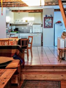 uma cozinha e sala de estar com mesa e cadeiras em maison immersion hautes alpes em Freissinieres