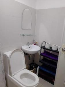 a bathroom with a white toilet and a sink at Uptown Condo Primavera Residences in Cagayan de Oro