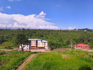 a building in the middle of a green field at Fully furnished two bedroom bnb in Thika town in Thika