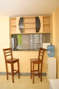 two chairs and a table in a kitchen at Fully furnished two bedroom bnb in Thika town in Thika