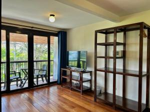 a living room with a desk and a balcony at Villa Salento Boutique Apartments & Spa in Salento