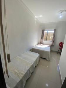 a room with two beds and a window at Casa Marques 3 ranchos in Três Ranchos