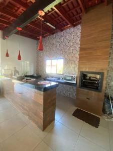 a large kitchen with a large island in the middle at Casa Marques 3 ranchos in Três Ranchos