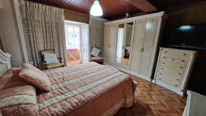 a bedroom with a bed and a dresser and a television at CUCA in Muxia