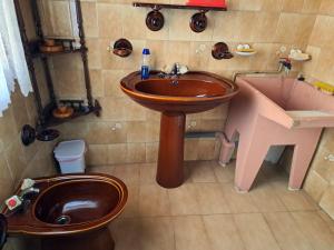 a bathroom with a sink and a toilet and a tub at CUCA in Muxia