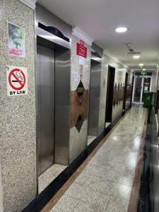 a hallway in a building with a sign on the wall at Partition Rooms in Hotel Apartment in Dubai