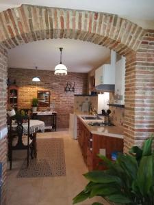 an open kitchen with a brick wall at VyVE Grazalema AT in Grazalema