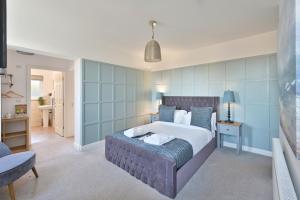 a bedroom with a large bed with blue walls at Rooms at The Dressers Arms in Chorley