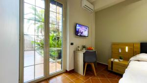 a bedroom with a bed and a large window at Country Sicily Home in Favara