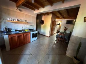 a kitchen with a sink and a stove top oven at Tierra Viva in Puerto Iguazú