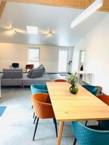 a living room with a table and chairs at Penthouse 3 bedrooms in center w. private garden in Luxembourg