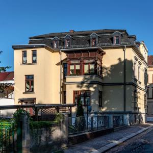 a large building with a fence in front of it at Villa Natalie Meerane in Meerane