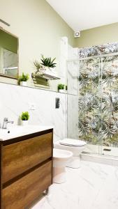 a bathroom with a toilet and a glass shower at Country Sicily Home in Favara +15 photos