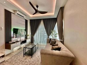 a living room with a couch and a ceiling fan at Sunset View at Modern Home in Kuala Lumpur